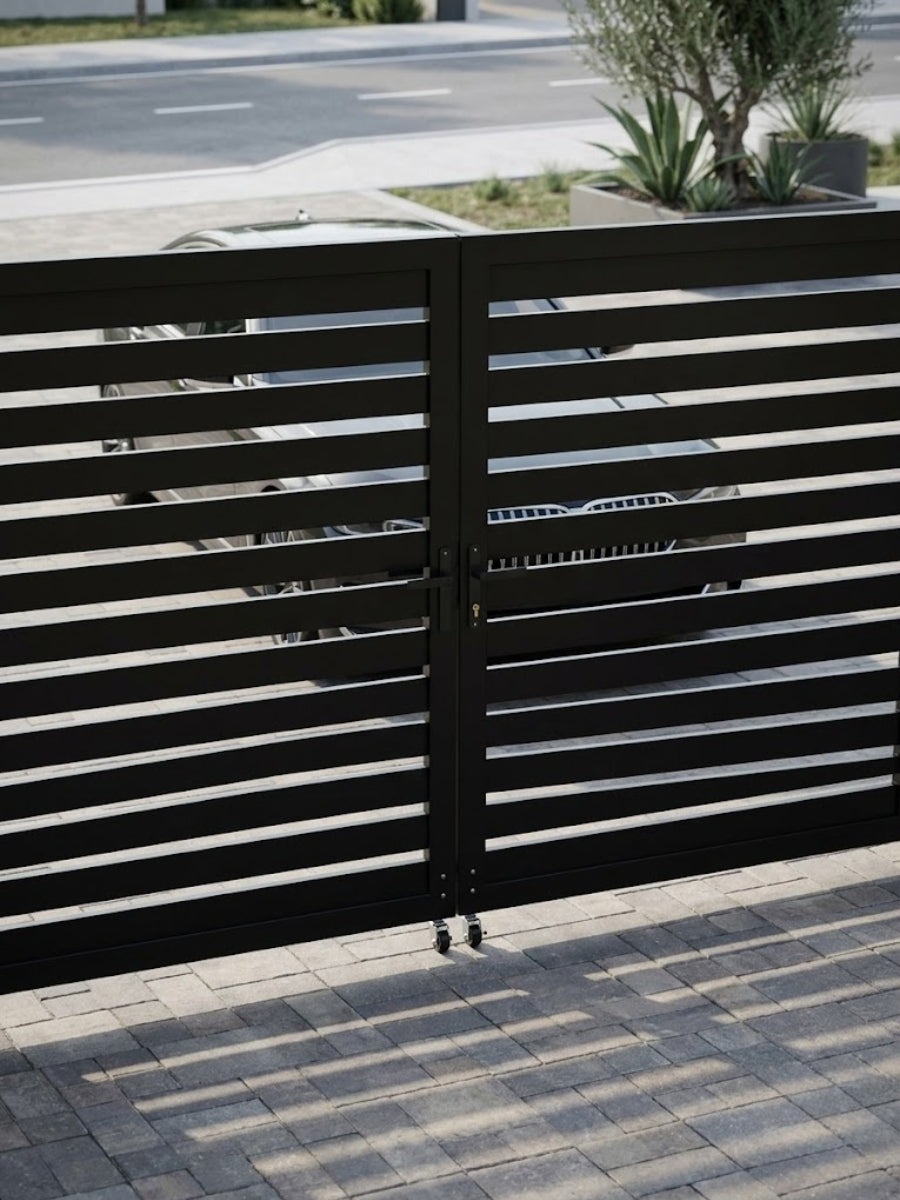 Black horizontal-slat aluminum driveway gate with parked vehicles visible behind it
