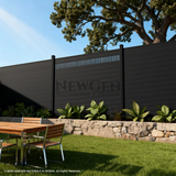 Modern decorative fence screen with vertical slats topping a dark backyard fence above an outdoor dining area