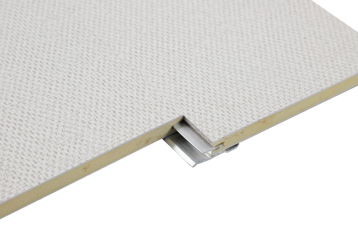 Aluminum invisible seamless trim connector partially exposed between two textured white panel edges