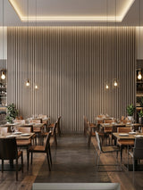 Floor-to-ceiling Ash Wood WPC fluted 3D feature wall in a restaurant dining room