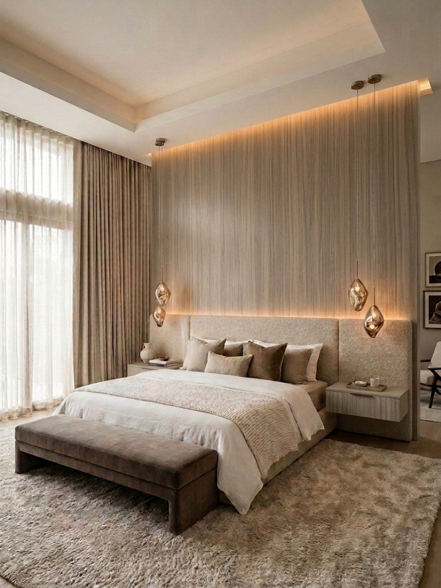 Ash wood veneer wall panels with vertical grain installed as a warmly lit bedroom feature wall behind the bed