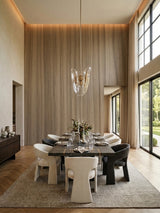 Vertical-grain ash wood veneer panels installed on a high dining room feature wall with warm ceiling lighting