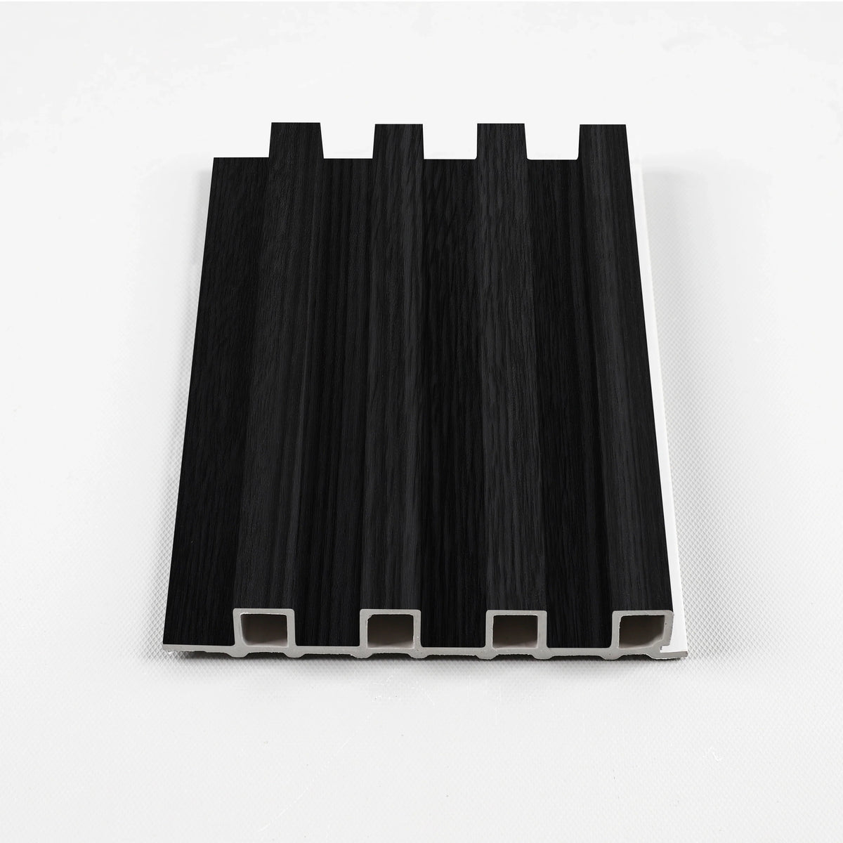 Ashen Oak WPC fluted wall panel sample in black with a subtle wood-grain texture