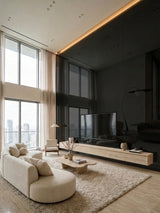 Reflective Black Mirror wood veneer panel accent wall in a double-height living room with a TV console