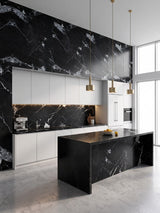 Black marble-look PVC wall panels with white veining installed across a modern kitchen wall and island