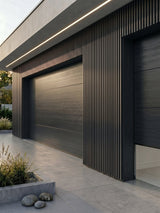 Wide gray and black composite cladding surrounding modern garage doors