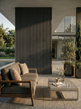 Gray and black vertical composite cladding accent wall on a covered outdoor patio