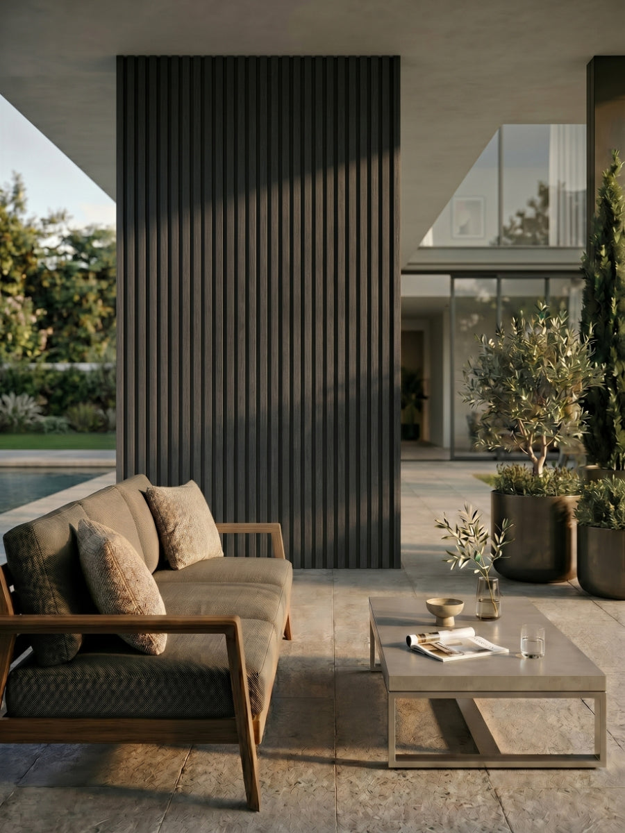 Gray and black vertical composite cladding accent wall on a covered outdoor patio