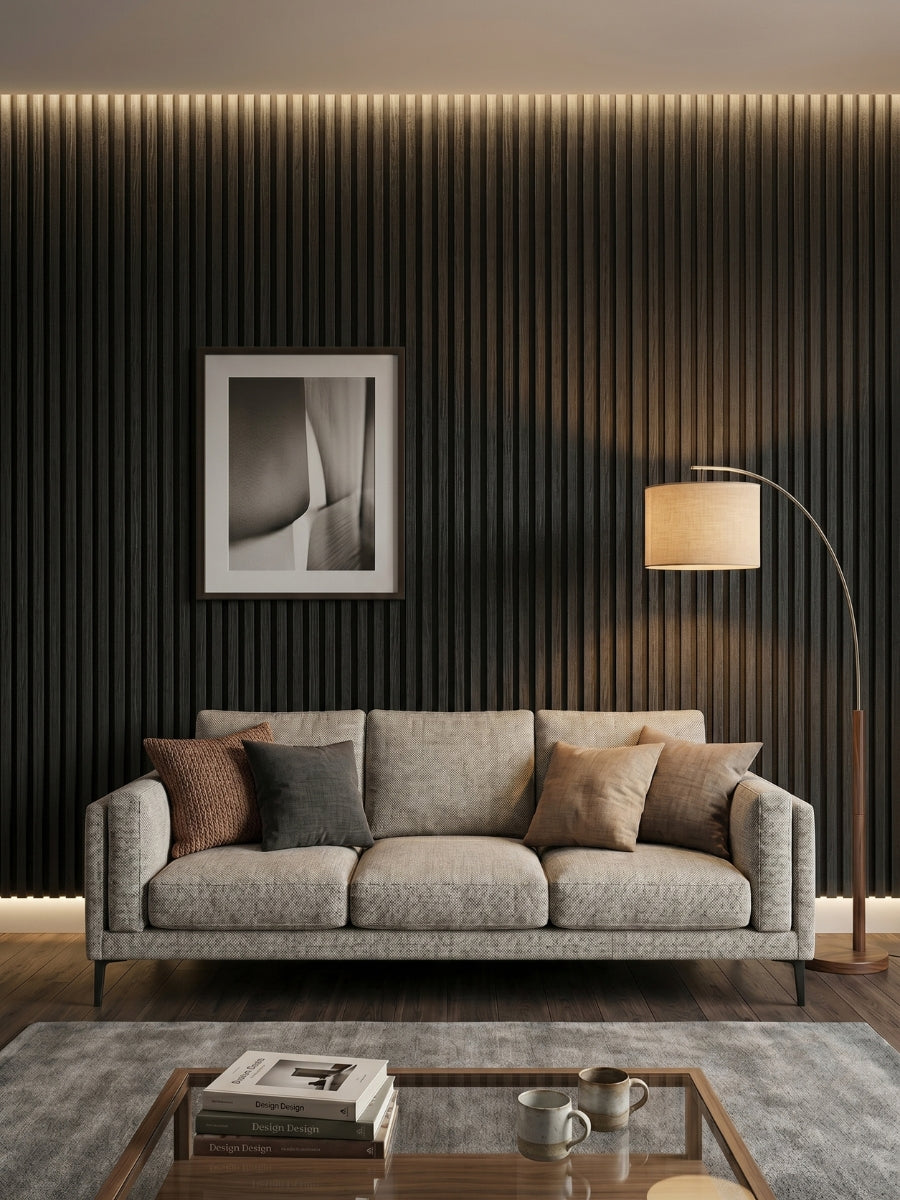 Blackwood WPC fluted 3D panels installed as a living room accent wall behind a gray sofa