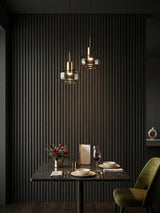 Blackwood WPC fluted 3D wall panels surrounding a dark dining nook with pendant lights