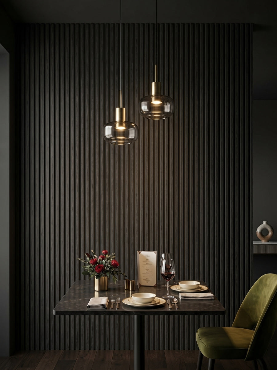 Blackwood WPC fluted 3D wall panels surrounding a dark dining nook with pendant lights