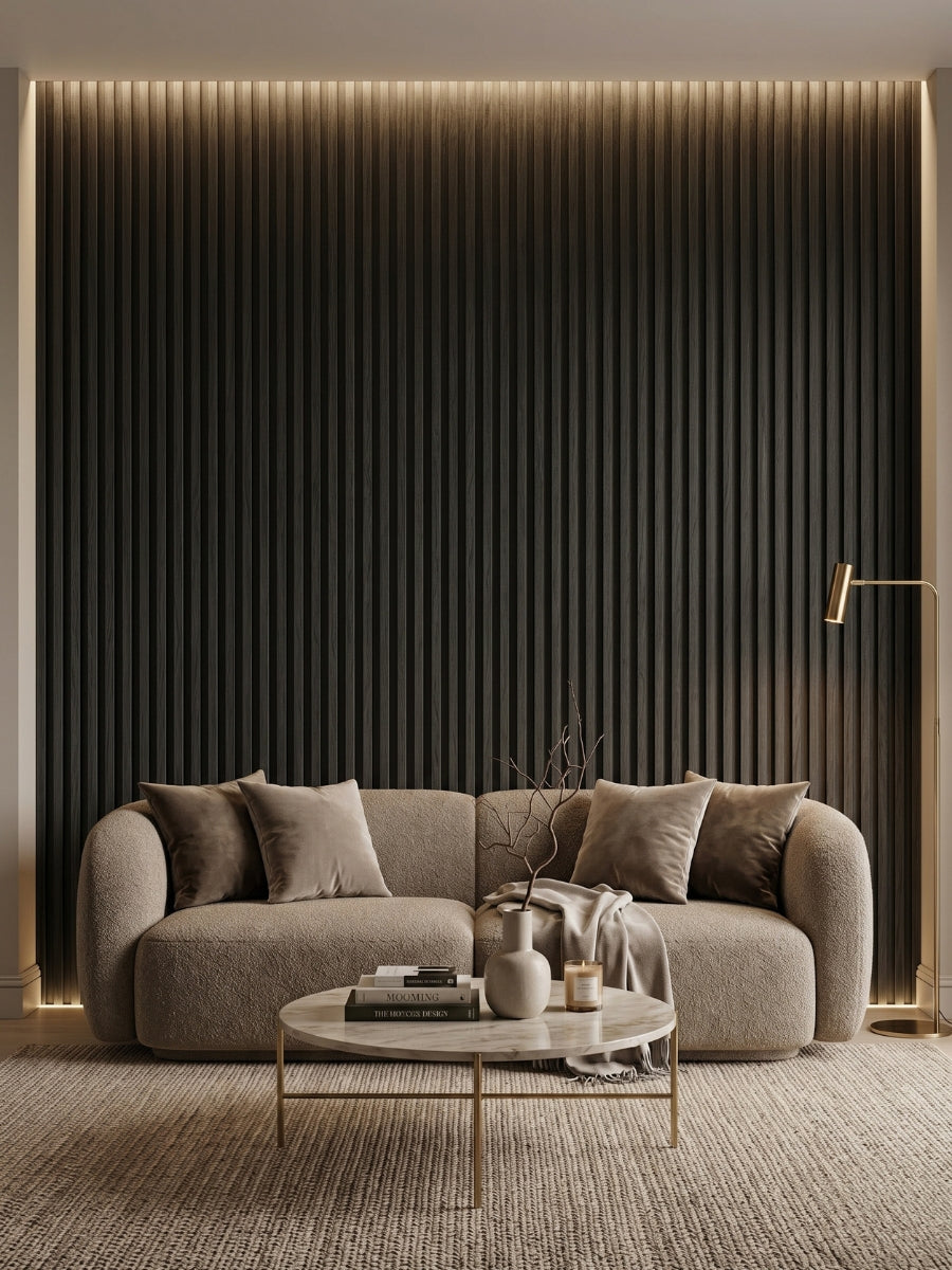 Floor-to-ceiling Blackwood WPC fluted wall panels behind a curved sofa in a modern living room