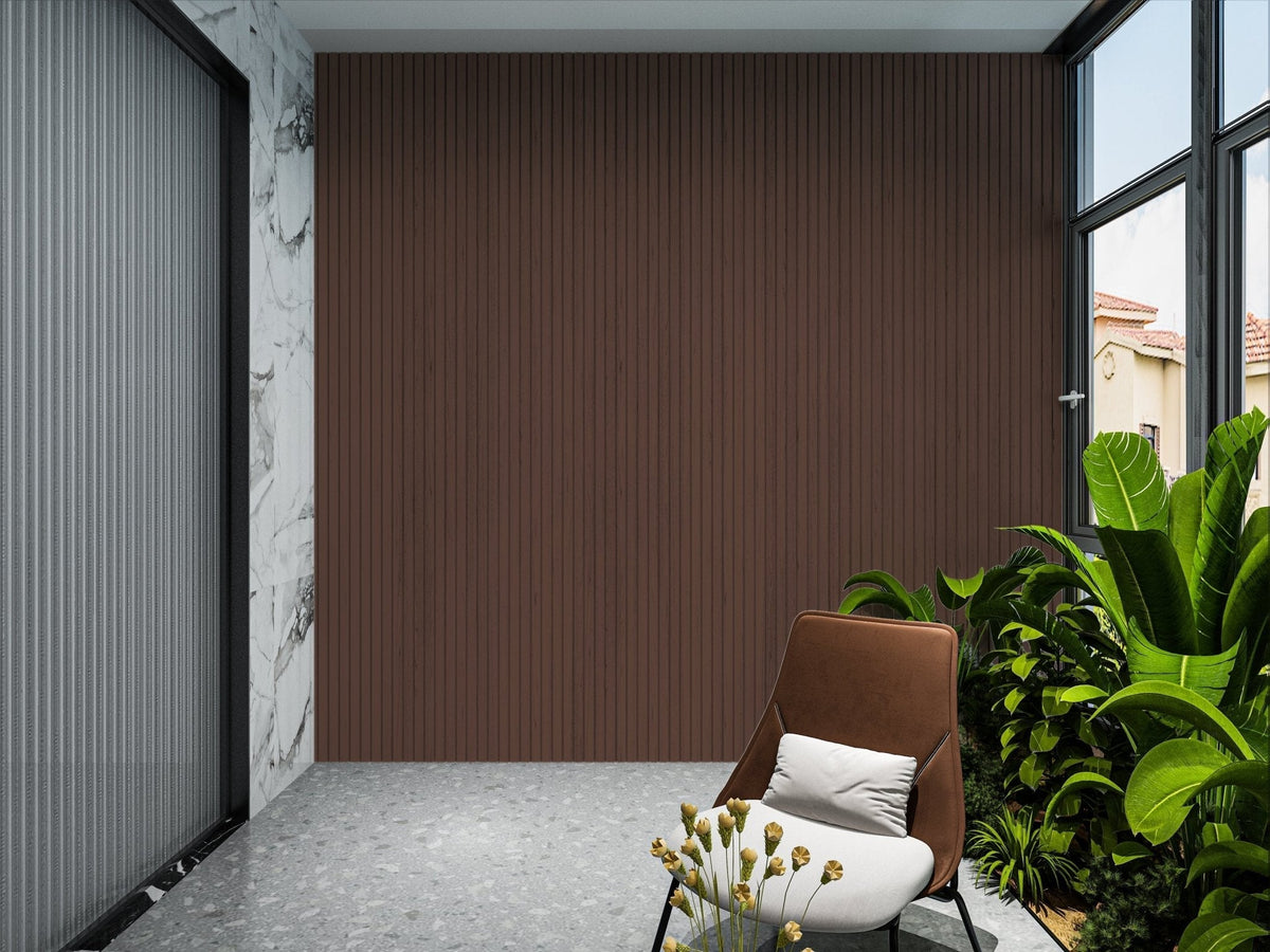 Dark brown composite cladding feature wall in a covered patio alcove with a lounge chair and tropical plants