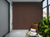 Dark brown composite cladding feature wall in a covered patio alcove with a lounge chair and tropical plants