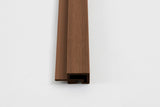 Close-up of brown wood-grain corner trim profile for composite wide exterior cladding
