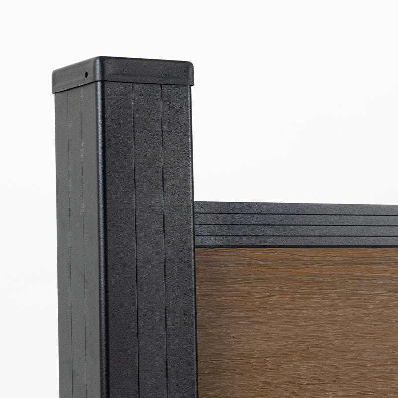 Close-up of a capped black fence post beside walnut composite boards and top rail