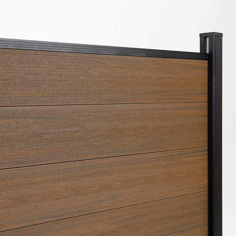 Close-up of walnut composite fence boards meeting a capped black side post