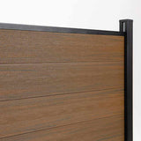 Close-up of walnut composite fence boards meeting a capped black side post