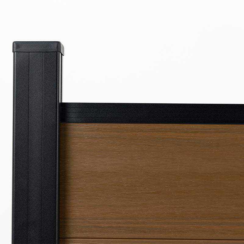 Close-up of walnut composite fence panel fitted into a capped black post