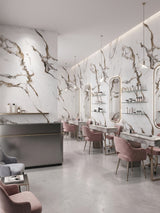 Calacatta Oro Gold marble-look PVC panels covering the walls of a modern salon with mirrors and pink styling chairs