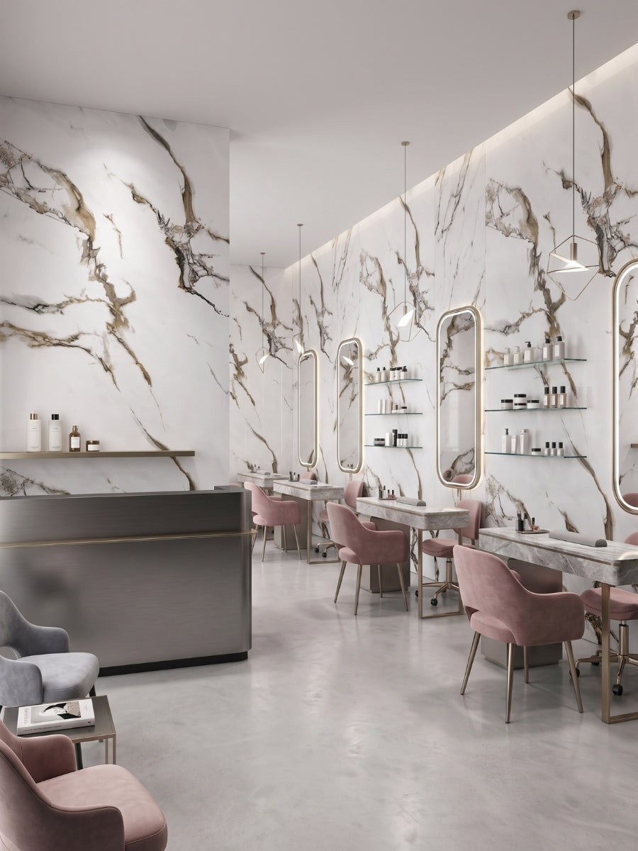 Calacatta Oro Gold marble-look PVC panels covering the walls of a modern salon with mirrors and pink styling chairs