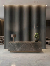 Carborn Gray WPC fluted 3D wall panels installed behind a marble reception desk