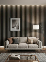 Carborn Gray WPC fluted 3D wall panels covering a living room wall behind a gray sofa