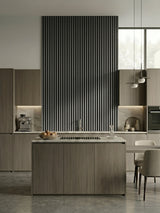 Carborn Gray WPC fluted 3D wall panels forming a tall kitchen accent wall behind an island