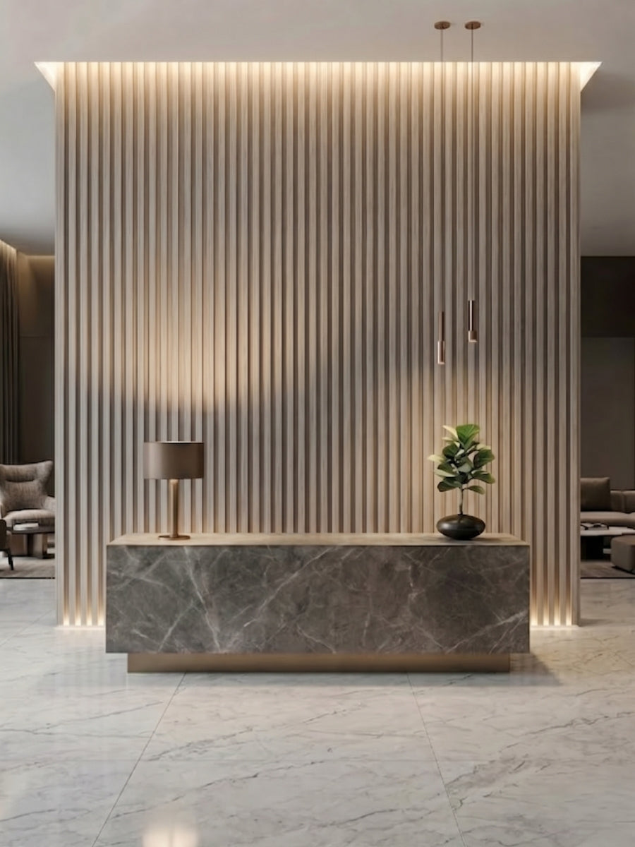 Reception area with a floor-to-ceiling Nordic Birch fluted panel wall behind a stone desk