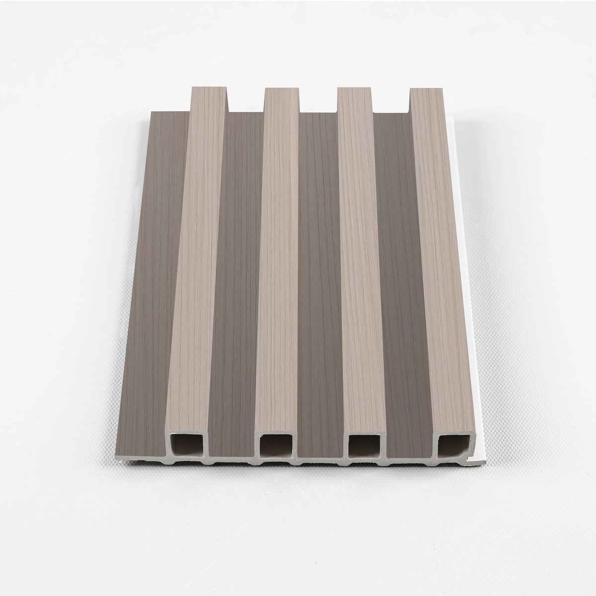 Cedar Oak WPC fluted wall panel sample in a pale taupe wood-grain finish