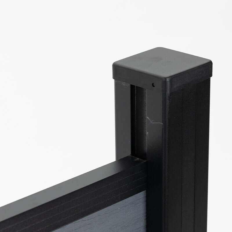 Close-up of the black fence post cap and upper rail connection