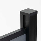 Close-up of the black fence post cap and upper rail connection