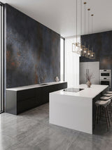 Graphite charcoal rough-texture PVC stone panels installed on walls in a modern black-and-white kitchen