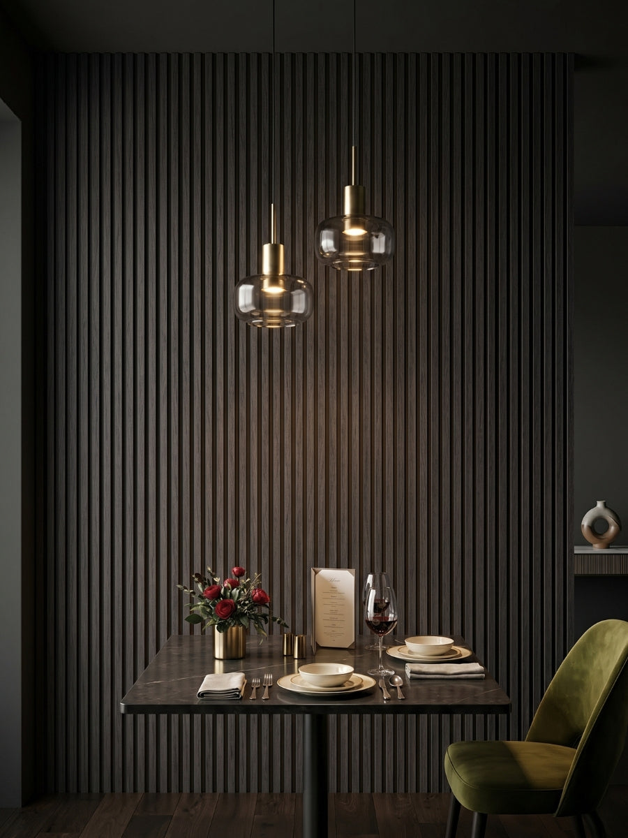 Dark Smoky Oak WPC fluted feature wall behind a dining table with pendant lights