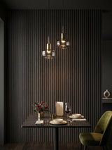 Dark Smoky Oak WPC fluted feature wall behind a dining table with pendant lights