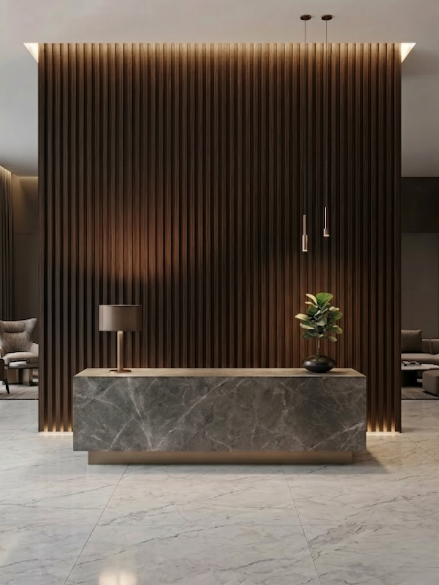 Reception desk set against a floor-to-ceiling Dark Walnut Oak WPC fluted 3D wall with warm lighting