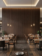 Restaurant interior with a large Dark Walnut Oak WPC fluted 3D feature wall behind dining tables
