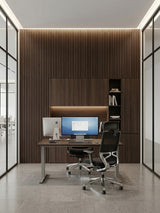 Modern office with Dark Walnut Oak WPC fluted wall panels surrounding a built-in desk and cabinets