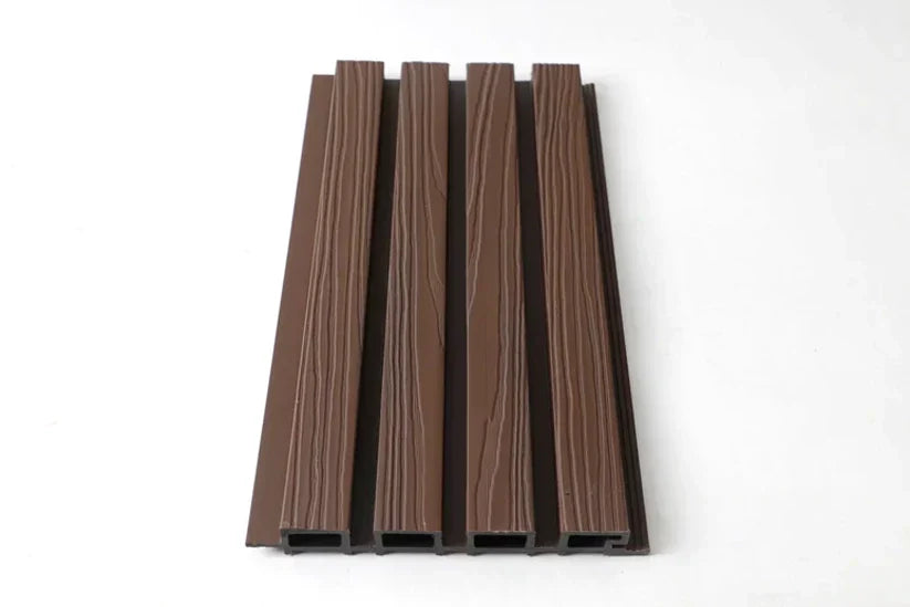 Angled view of dark brown composite wide exterior cladding with four raised wood-grain slats and hollow ends