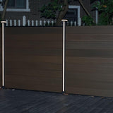 Two illuminated LED strips on posts along a dark composite privacy fence