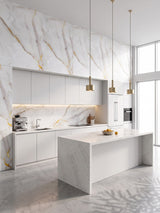 Empress Gold polished PVC marble sheets installed as a backsplash and upper feature wall in a modern white kitchen
