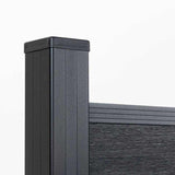 Close-up of a capped black fence post, top rail, and wood-grain composite panel