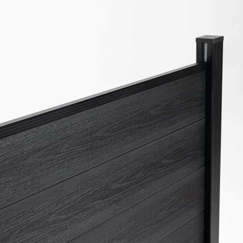 Close-up of black composite fence boards, top rail, and capped corner post