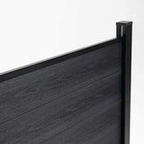 Close-up of black composite fence boards, top rail, and capped corner post