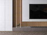 Wood-look acoustic slat wall panels framing a television in a minimalist living room
