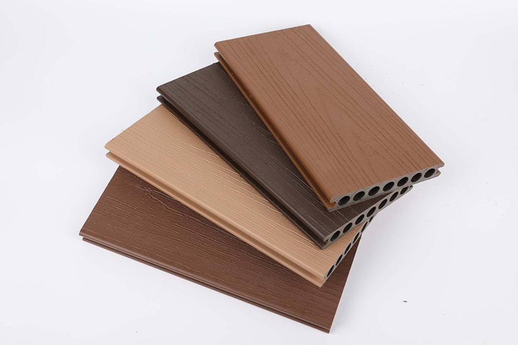 A stack of durable teak composite deck boards in warm brown shades