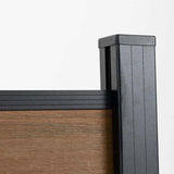 Close-up of black capped post and top rail on walnut composite fencing
