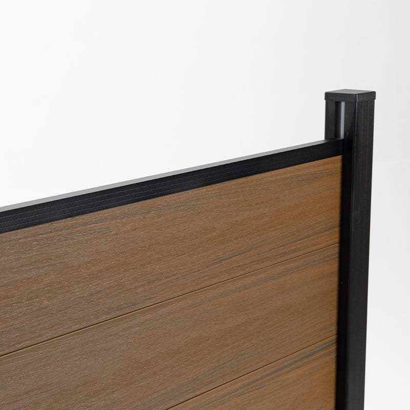 Top corner detail of walnut composite fence boards with black rail and capped post