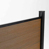 Top corner detail of walnut composite fence boards with black rail and capped post