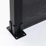Close-up of a black fence post mounting plate and adjoining composite boards